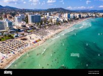 spain-balearic-islands-cala-bona-aerial-view-of-resort-town-and-crowded-beach-in-summer-2BH2C9...jpg
